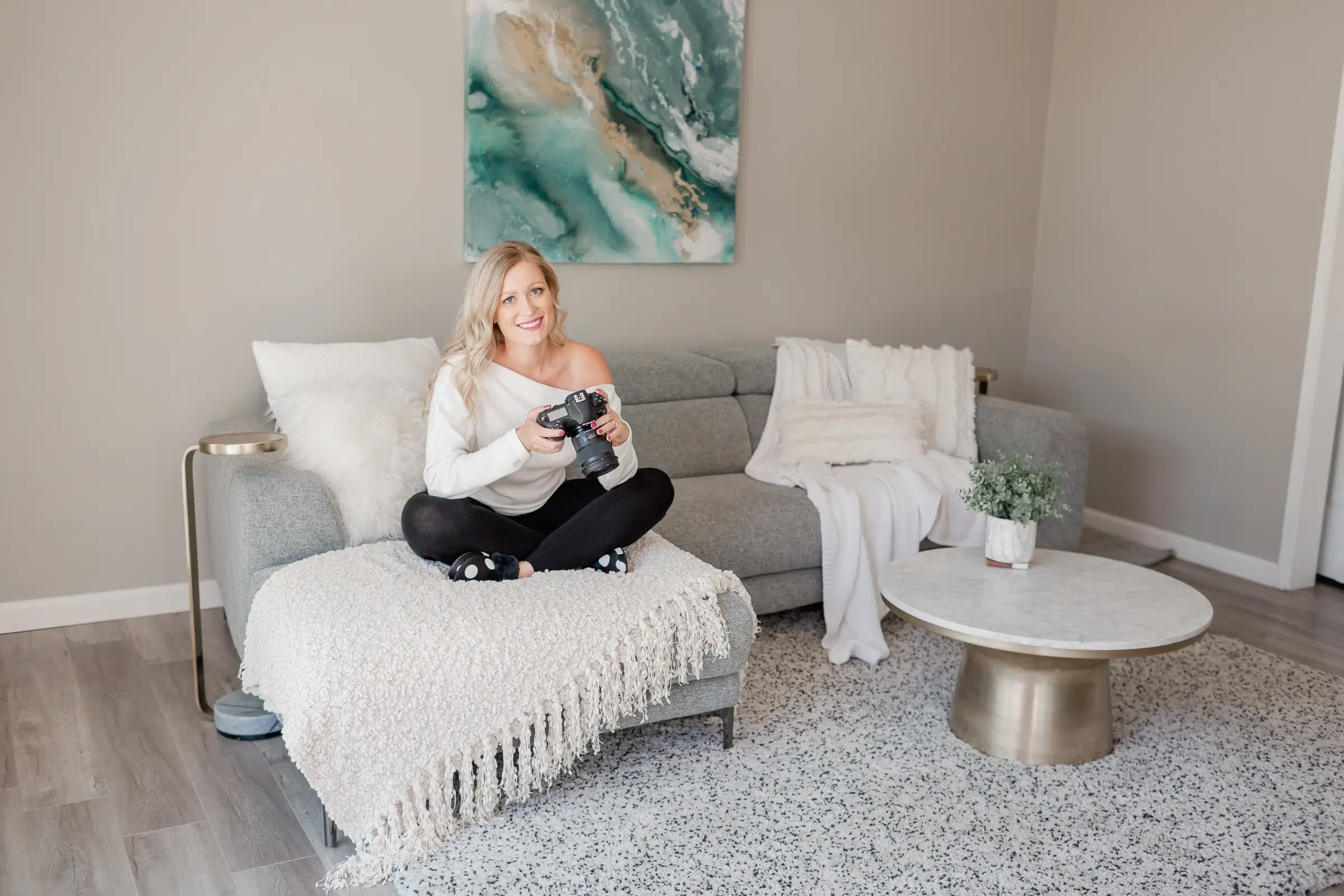 Smiling photographer sitting on couch