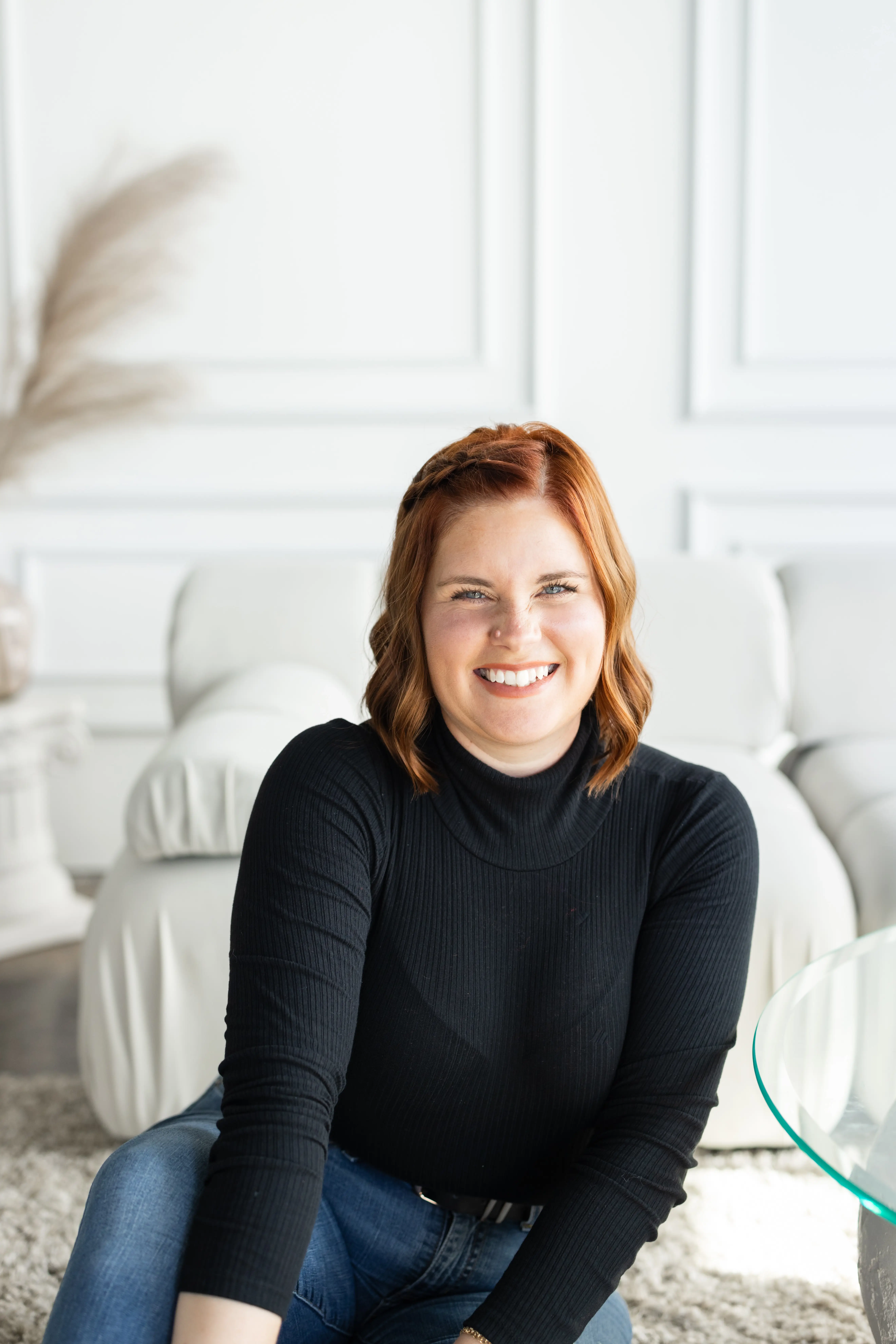 Smiling woman in cozy indoor setting.