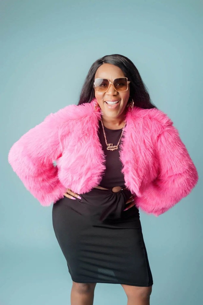 Smiling woman in pink fur jacket